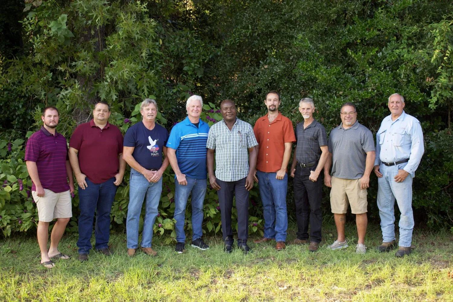 The US board and volunteer team standing together outdoors